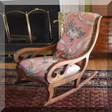 F55. Rocking chair with pink upholstery.  